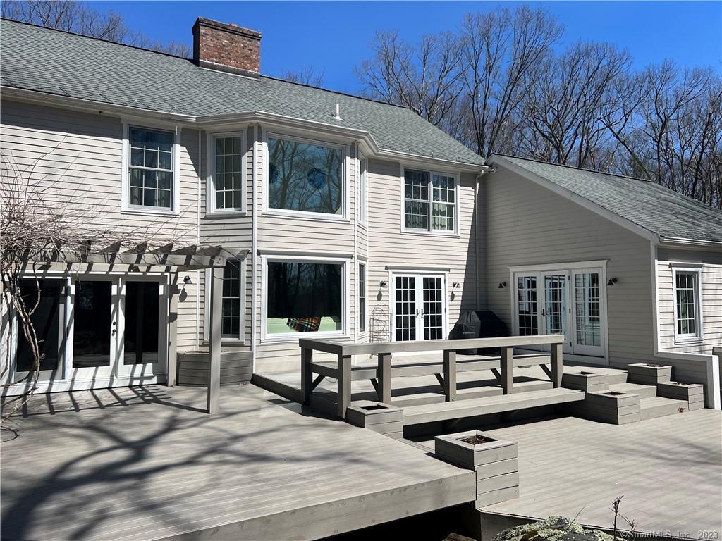 104 Lower Church Hill Road Washington, CT 06794 - Photo 2 of 23 a view of a patio with couches table and chairs with wooden floor and fence