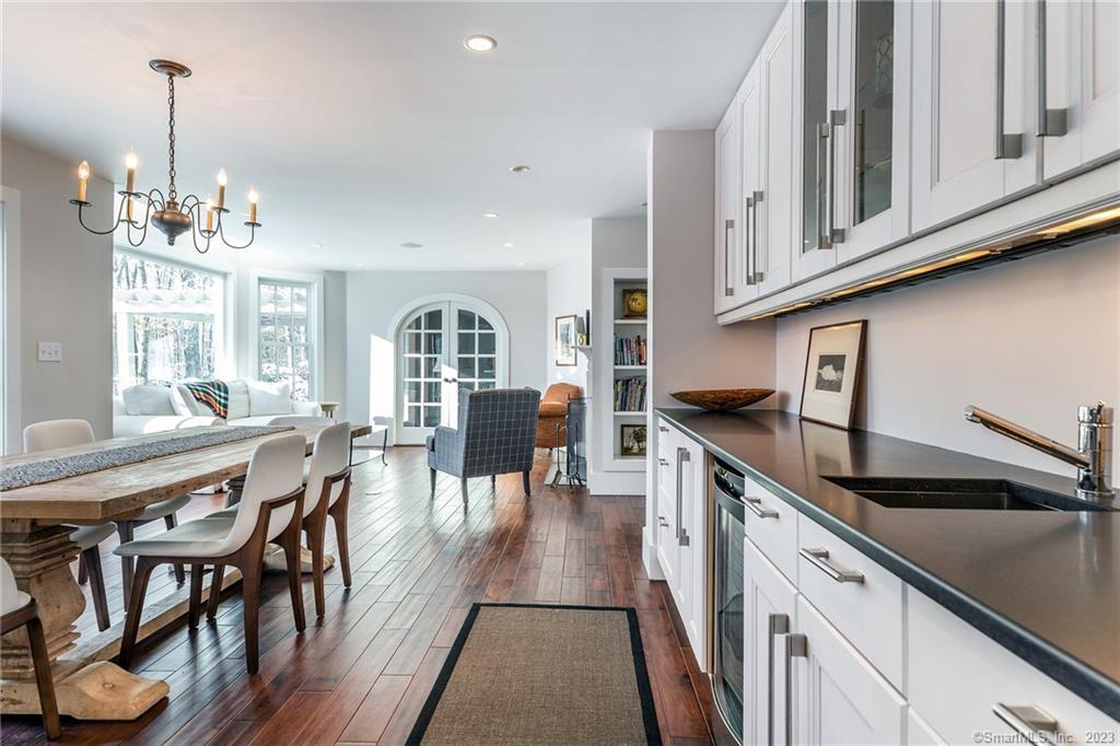 104 Lower Church Hill Road Washington, CT 06794 - Photo 5 of 23 a kitchen with stainless steel appliances granite countertop a kitchen island a stove a table and chairs