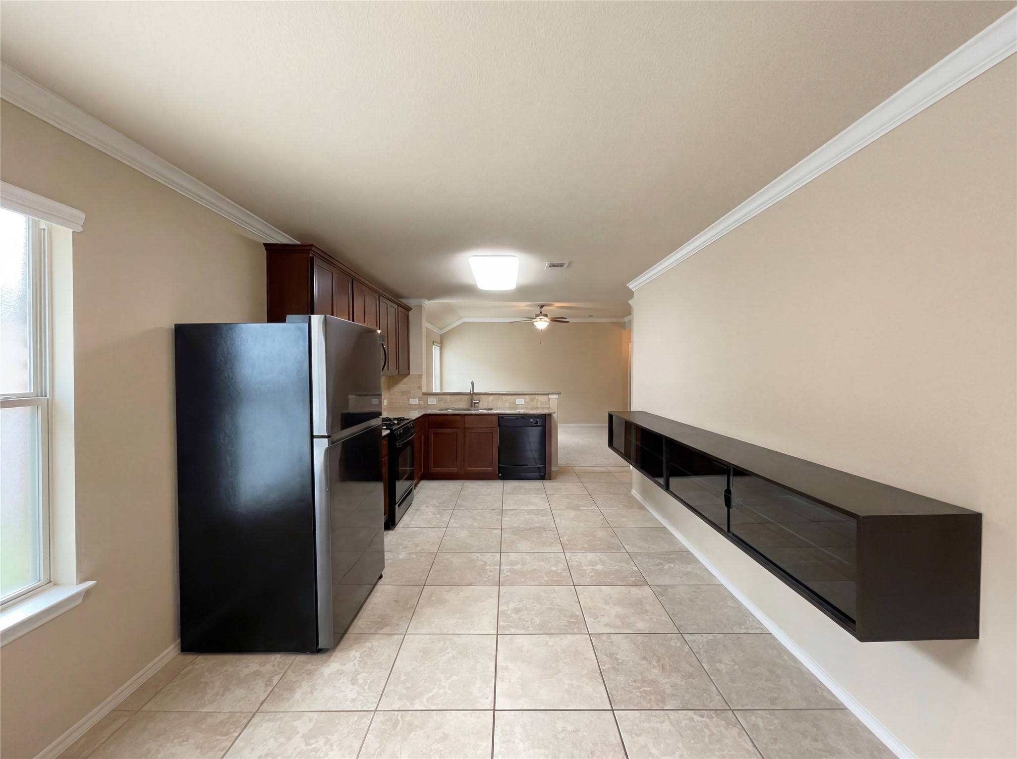 7208 Outfitter Drive Austin, TX 78744 - Photo 18 of 34 a kitchen with stainless steel appliances a refrigerator and a counter top space