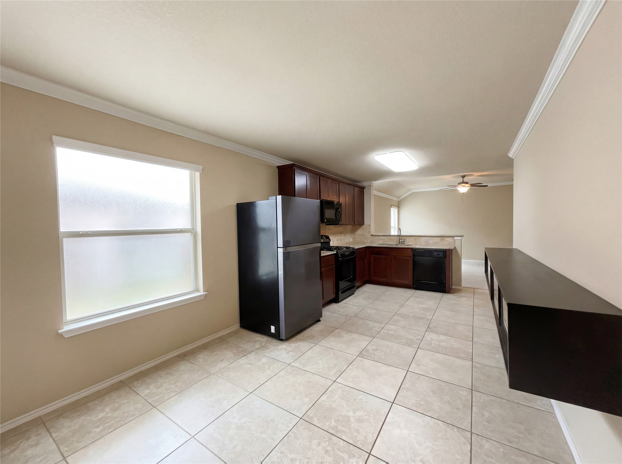 7208 Outfitter Drive Austin, TX 78744 - Photo 19 of 34 a large kitchen with a refrigerator and microwave