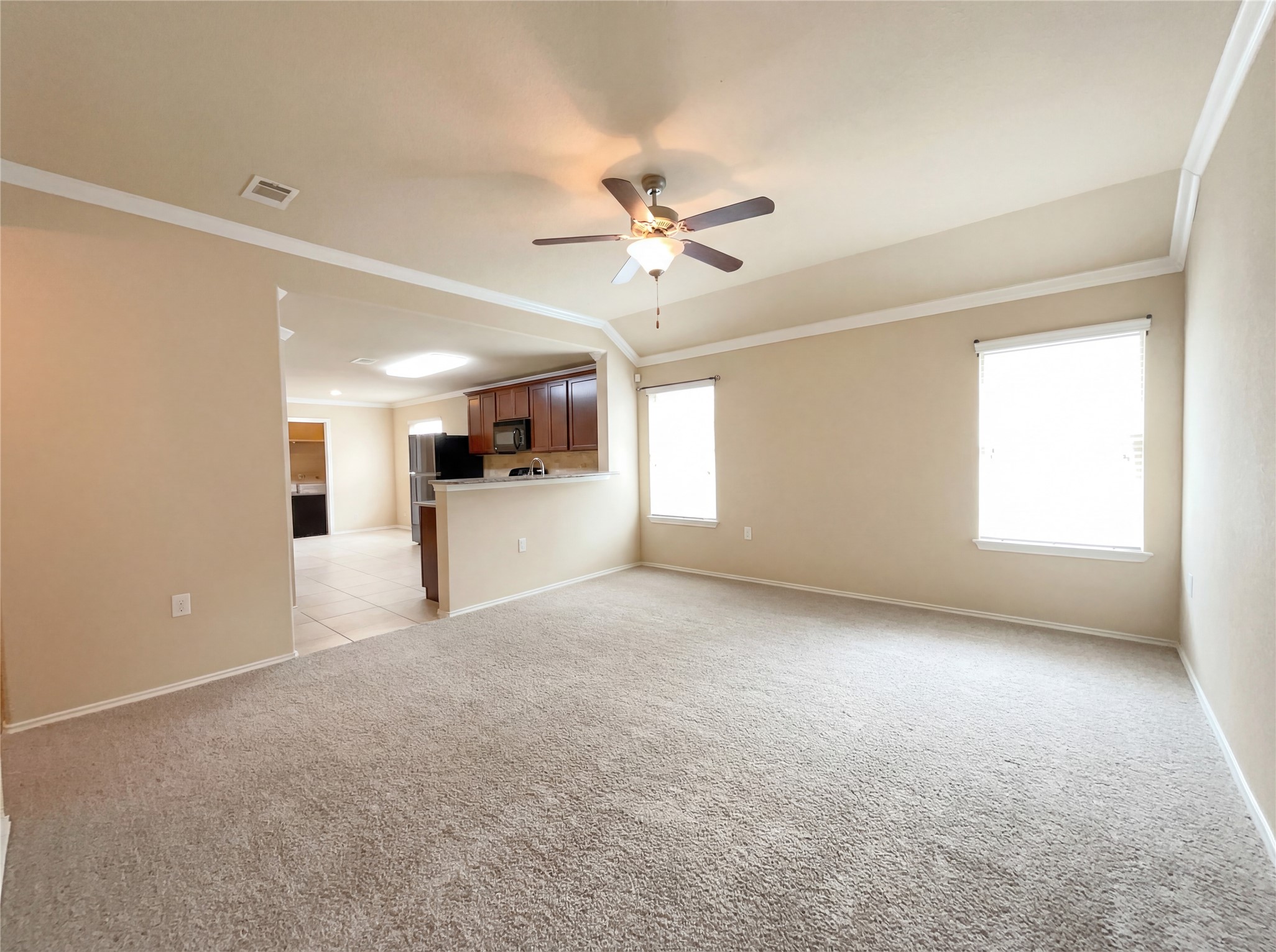 7208 Outfitter Drive Austin, TX 78744 - Photo 8 of 34 a view of a livingroom with a ceiling fan and window