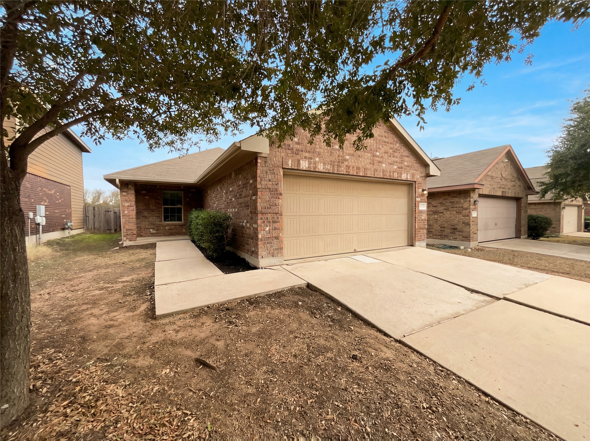 7208 Outfitter Drive Austin, TX 78744 - Photo 9 of 34 a front view of a house with a yard and garage