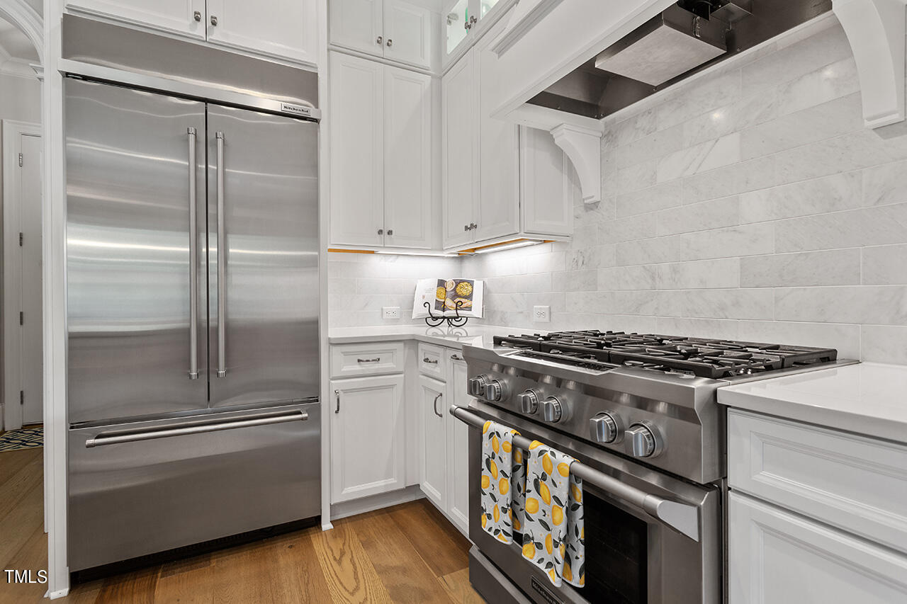 913 Canterbury Road Raleigh, NC 27607 - Photo 13 of 36 a stove top oven sitting inside of a kitchen