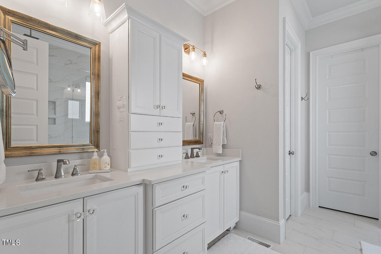 913 Canterbury Road Raleigh, NC 27607 - Photo 17 of 36 a bathroom with a granite countertop sink mirror and double