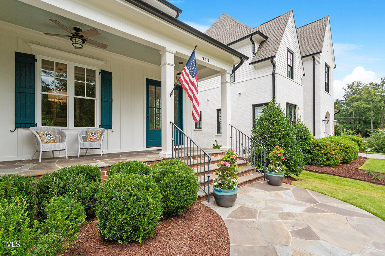 913 Canterbury Road Raleigh, NC 27607 - Photo 2 of 36 a front view of a house with a chairs and table in a patio