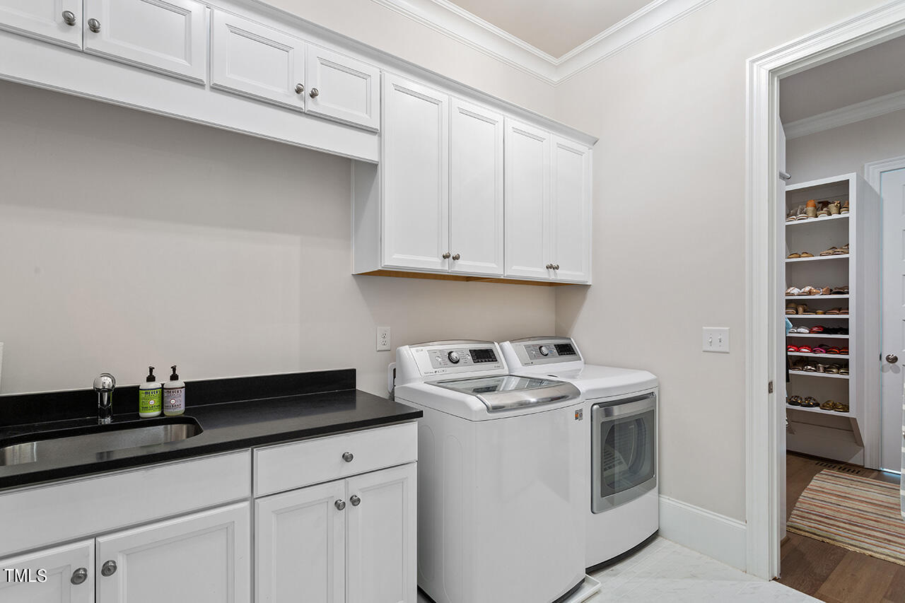 913 Canterbury Road Raleigh, NC 27607 - Photo 21 of 36 a kitchen with granite countertop white cabinets and white appliances