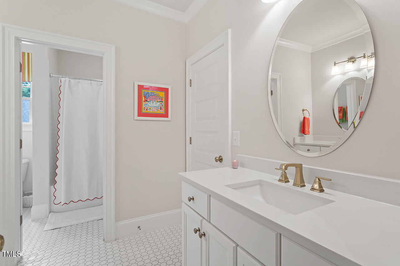 913 Canterbury Road Raleigh, NC 27607 - Photo 24 of 36 a bathroom with a sink and a mirror
