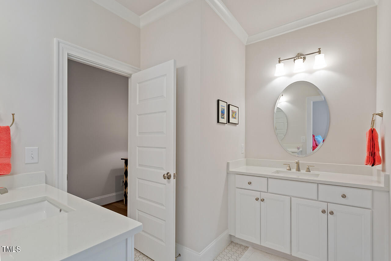 913 Canterbury Road Raleigh, NC 27607 - Photo 25 of 36 a bathroom with a sink and a mirror