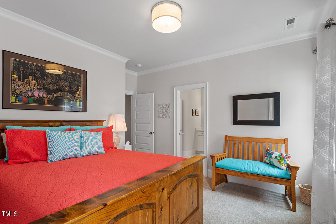 913 Canterbury Road Raleigh, NC 27607 - Photo 26 of 36 a bedroom with a bed and a painting on the wall