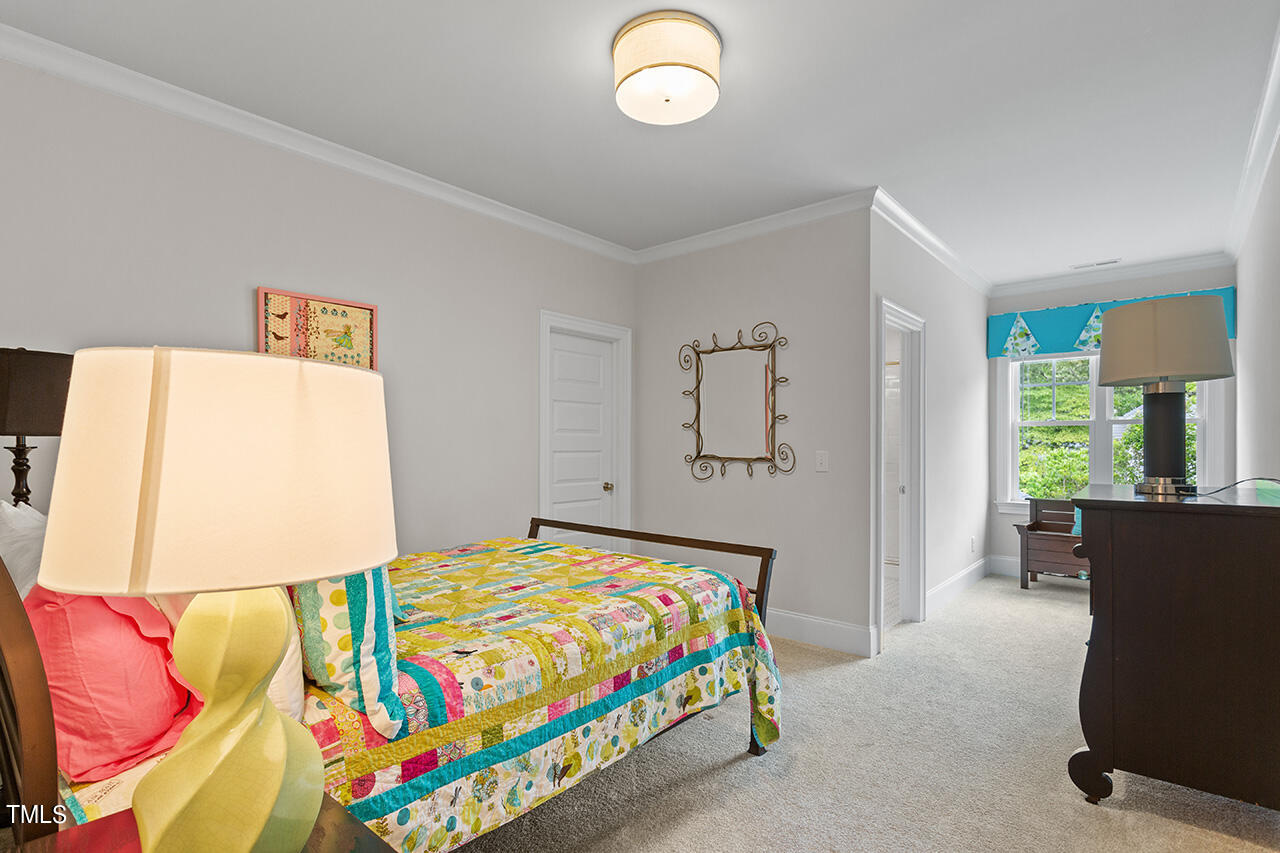 913 Canterbury Road Raleigh, NC 27607 - Photo 27 of 36 a bedroom with a bed and a window