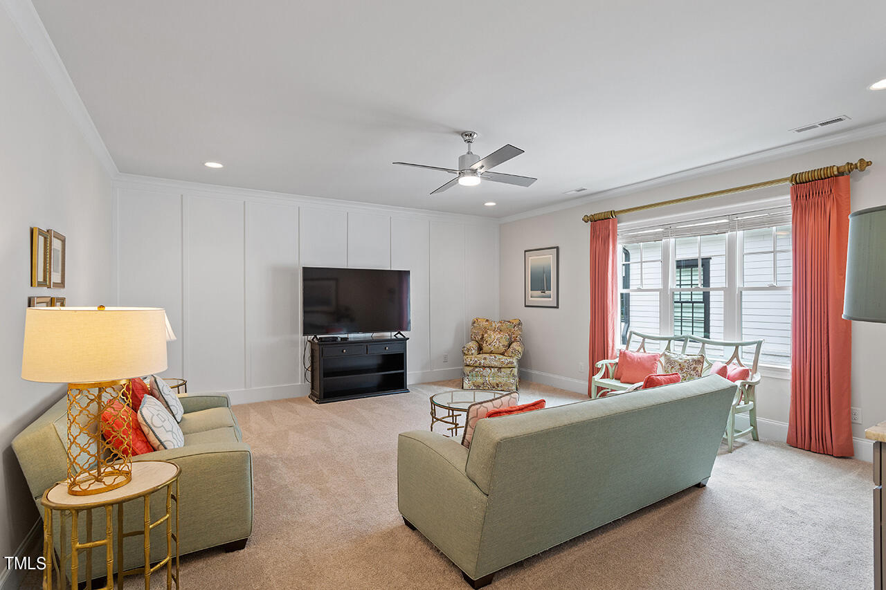 913 Canterbury Road Raleigh, NC 27607 - Photo 29 of 36 a living room with furniture and a flat screen tv