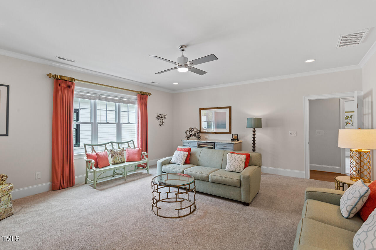 913 Canterbury Road Raleigh, NC 27607 - Photo 30 of 36 a living room with furniture and a flat screen tv