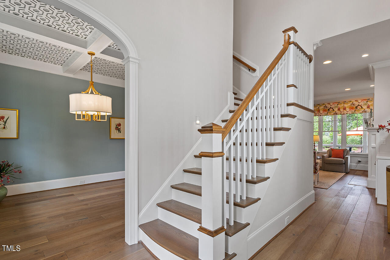 913 Canterbury Road Raleigh, NC 27607 - Photo 3 of 36 a view of entryway with wooden floor and stairs