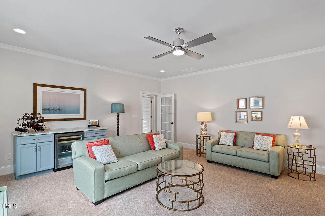 913 Canterbury Road Raleigh, NC 27607 - Photo 31 of 36 a living room with furniture a chandelier and a window