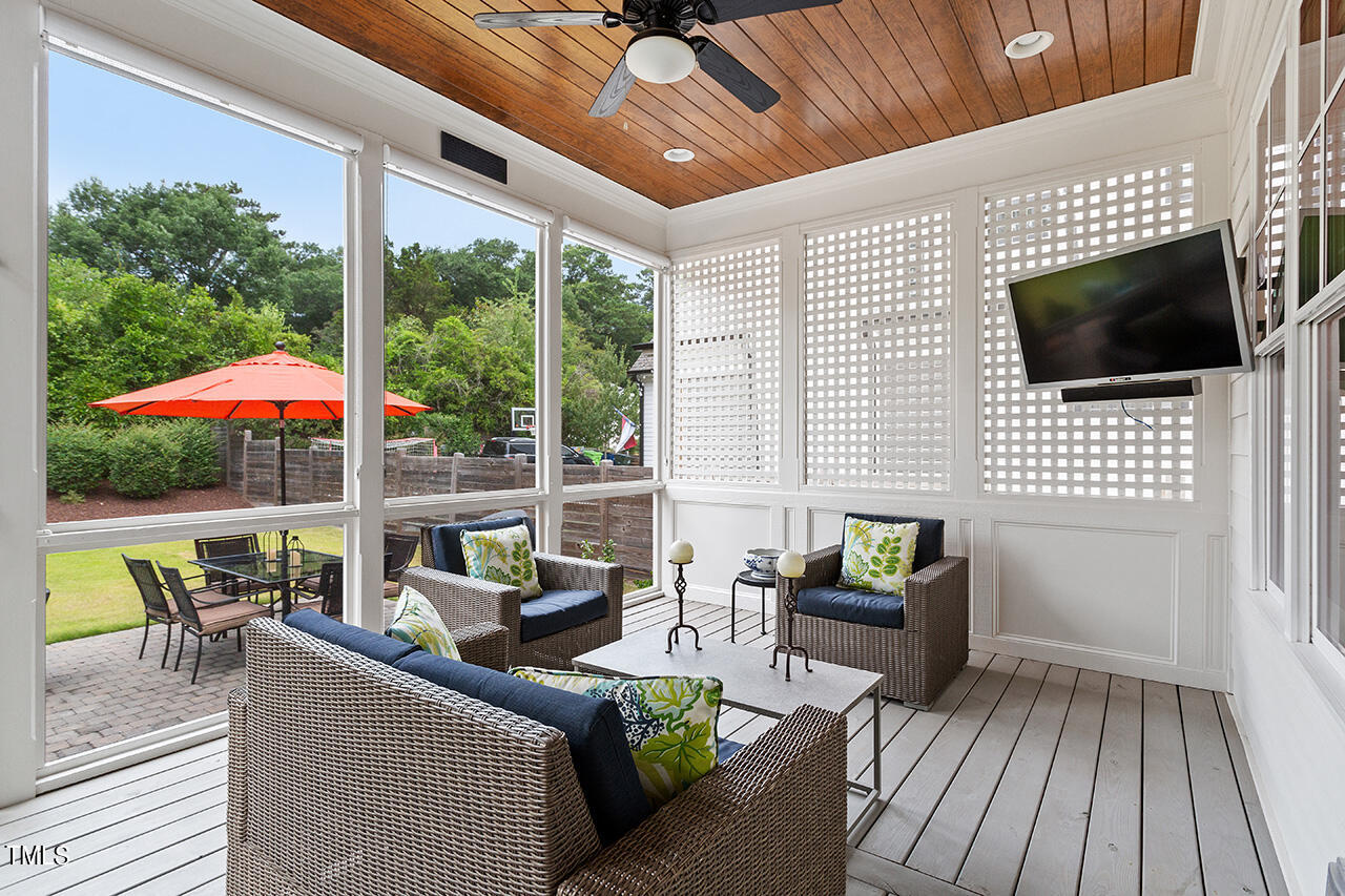913 Canterbury Road Raleigh, NC 27607 - Photo 35 of 36 a living room with furniture and a flat screen tv
