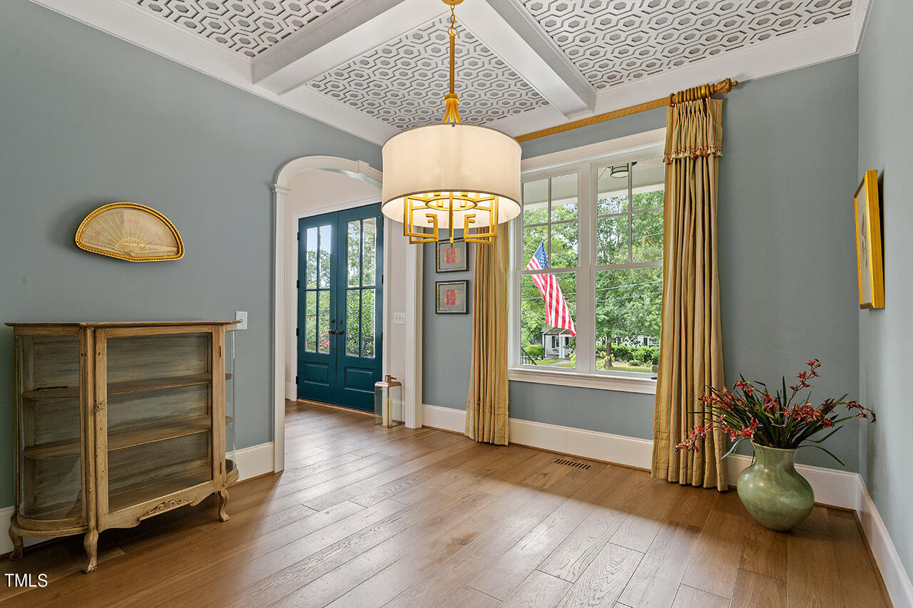 913 Canterbury Road Raleigh, NC 27607 - Photo 4 of 36 a view of an entryway with wooden floor windows and a chandelier