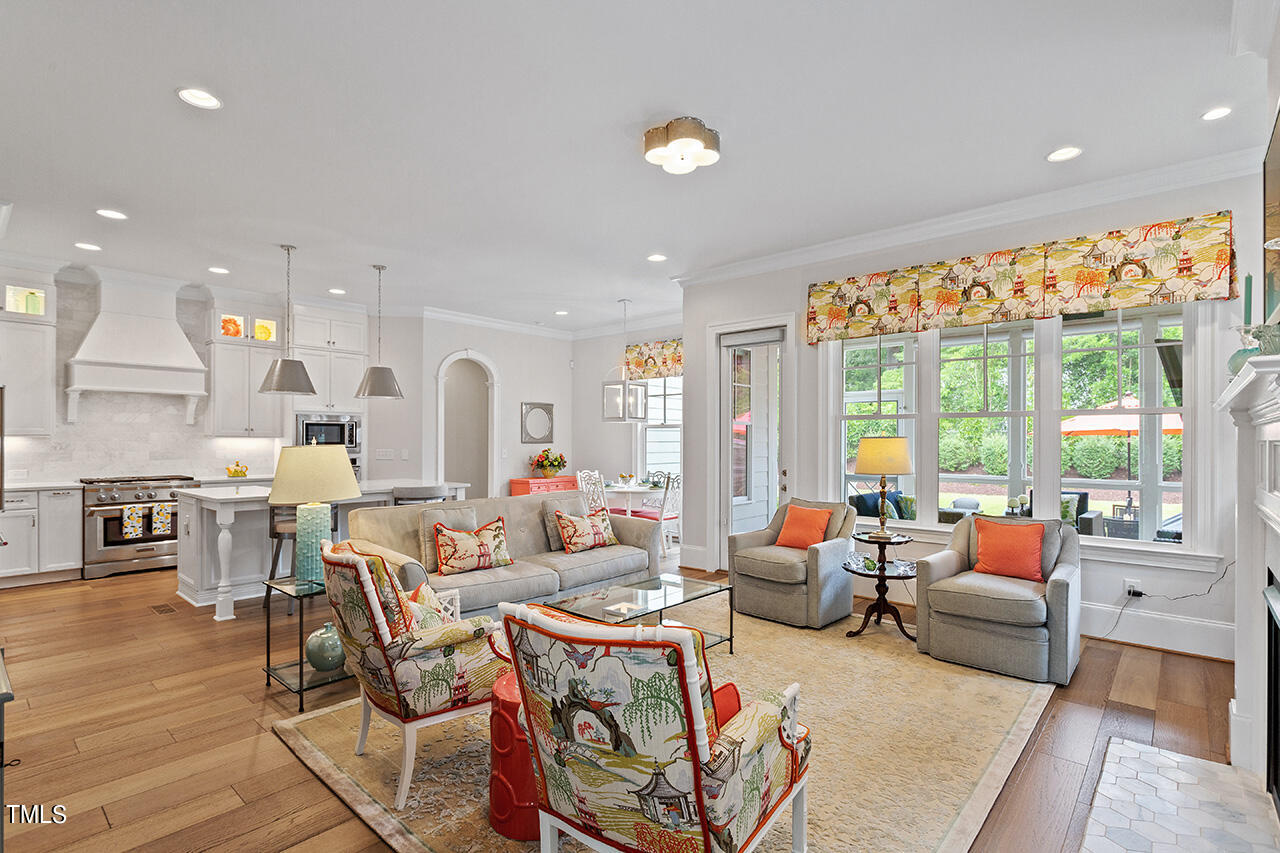 913 Canterbury Road Raleigh, NC 27607 - Photo 5 of 36 a living room with fireplace furniture and a large window