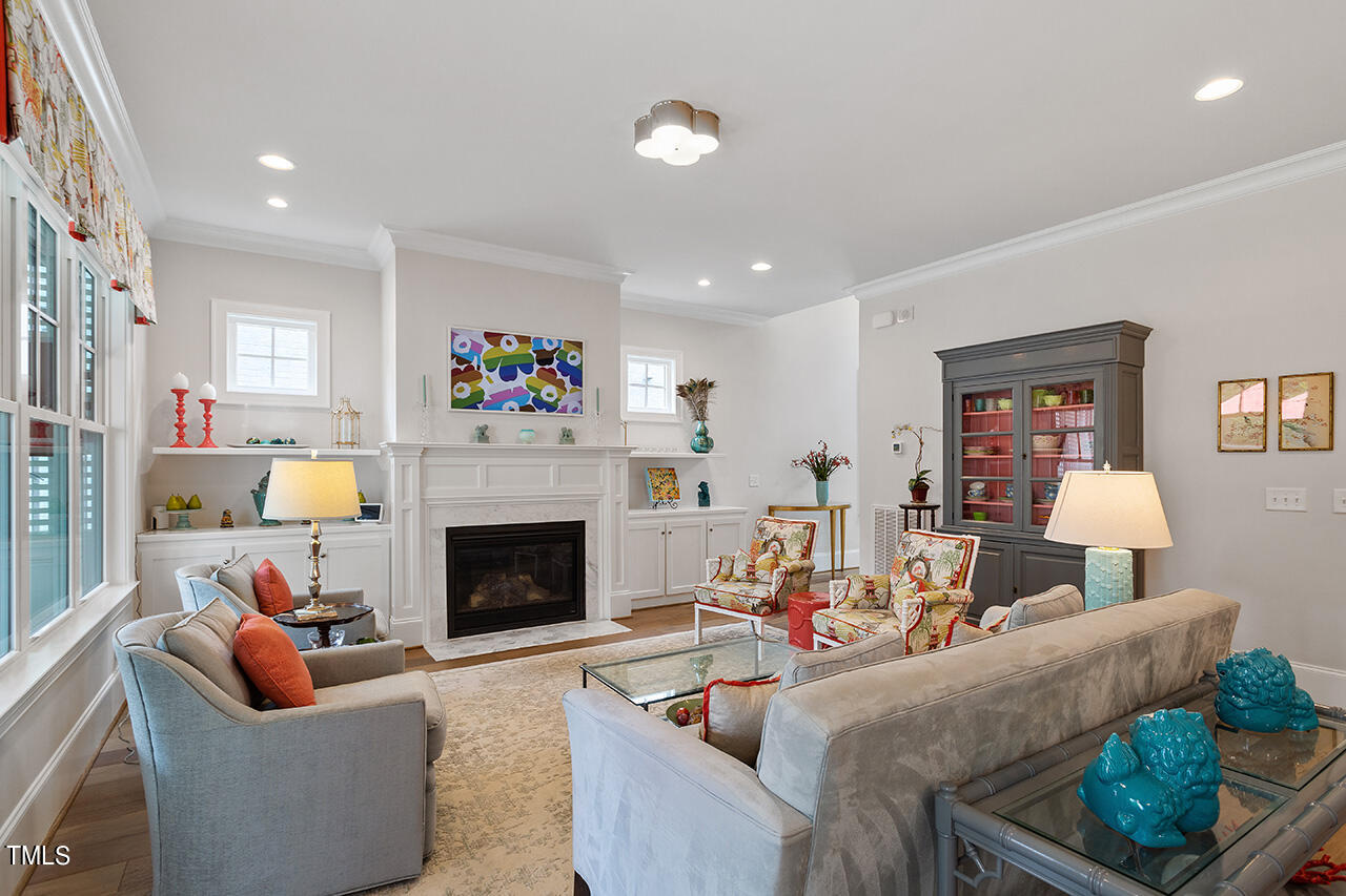 913 Canterbury Road Raleigh, NC 27607 - Photo 7 of 36 a living room with furniture fireplace and a window