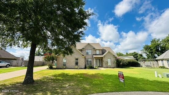 241 Stone Ridge Cove Medina, TN 38355 - Photo 2 of 59 a house view with swimming pool and trees in the background