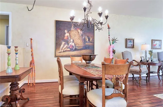 a view of a dining room with furniture wooden floor and chandelier