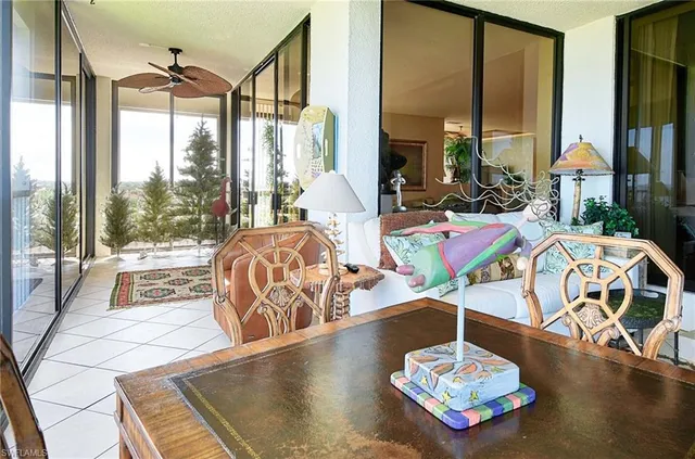 a living room with table or chairs and a floor to ceiling window