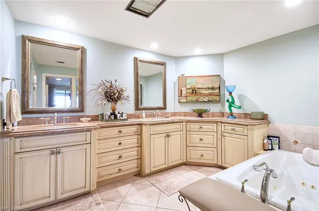 a spacious bathroom with a granite countertop sink and a mirror