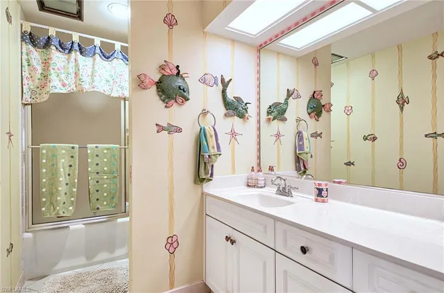 a bathroom with a double vanity sink mirror and shower