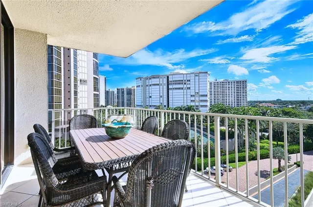 a view of a balcony with a table and chairs