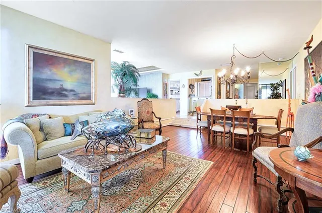 a living room with fireplace furniture and wooden floor