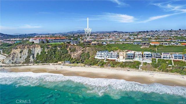 a kitchen with stainless steel appliances kitchen island granite countertop a table chairs and a refrigerator