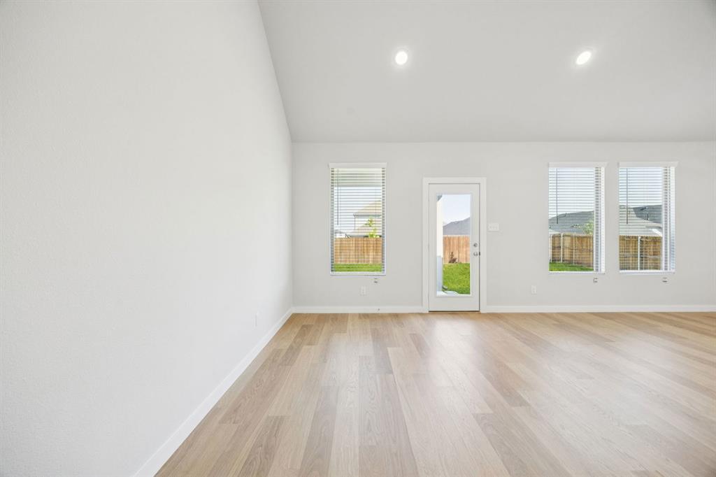 5803 Rushing River Way McKinney, TX 75071 - Photo 12 of 34 wooden floor in an empty room with a window