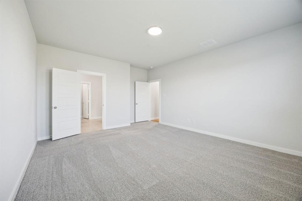 5803 Rushing River Way McKinney, TX 75071 - Photo 17 of 34 a view of an empty room and chandelier fan