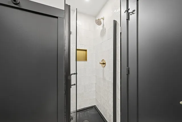 a bathroom with a shower and a mirror