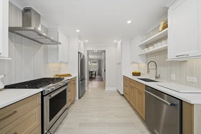 a kitchen with stainless steel appliances a sink stove and cabinets