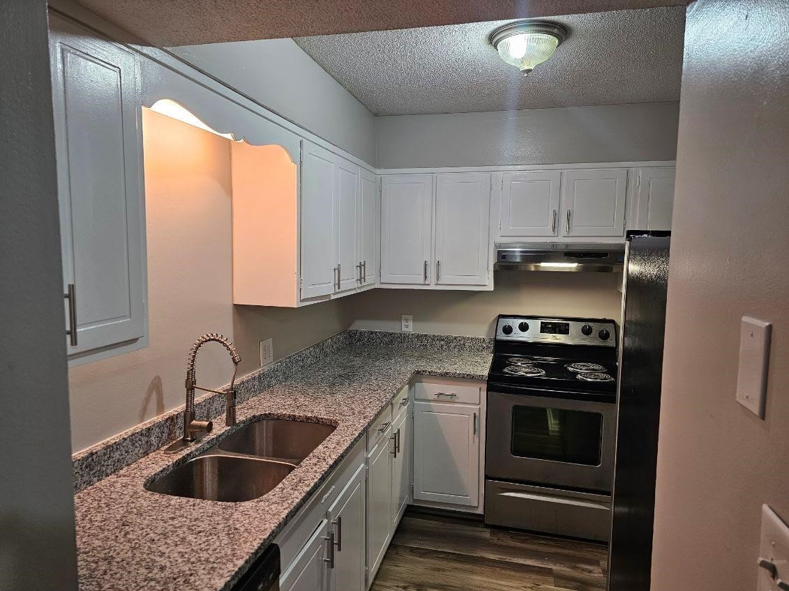 5052 Flint Ridge Place, Unit 5052 Raleigh, NC 27609 - Photo 2 of 67 a kitchen that has a sink and a stove