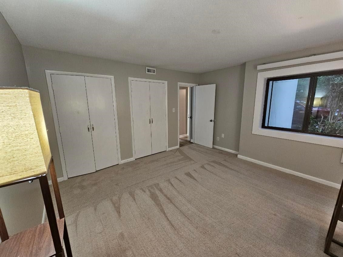 5052 Flint Ridge Place, Unit 5052 Raleigh, NC 27609 - Photo 23 of 67 a view of an empty room with window and closet area