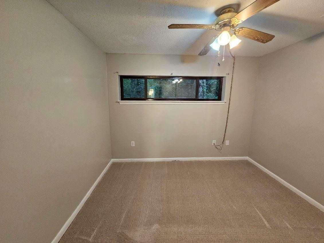 5052 Flint Ridge Place, Unit 5052 Raleigh, NC 27609 - Photo 31 of 67 an empty room with a fan & a ceiling fan