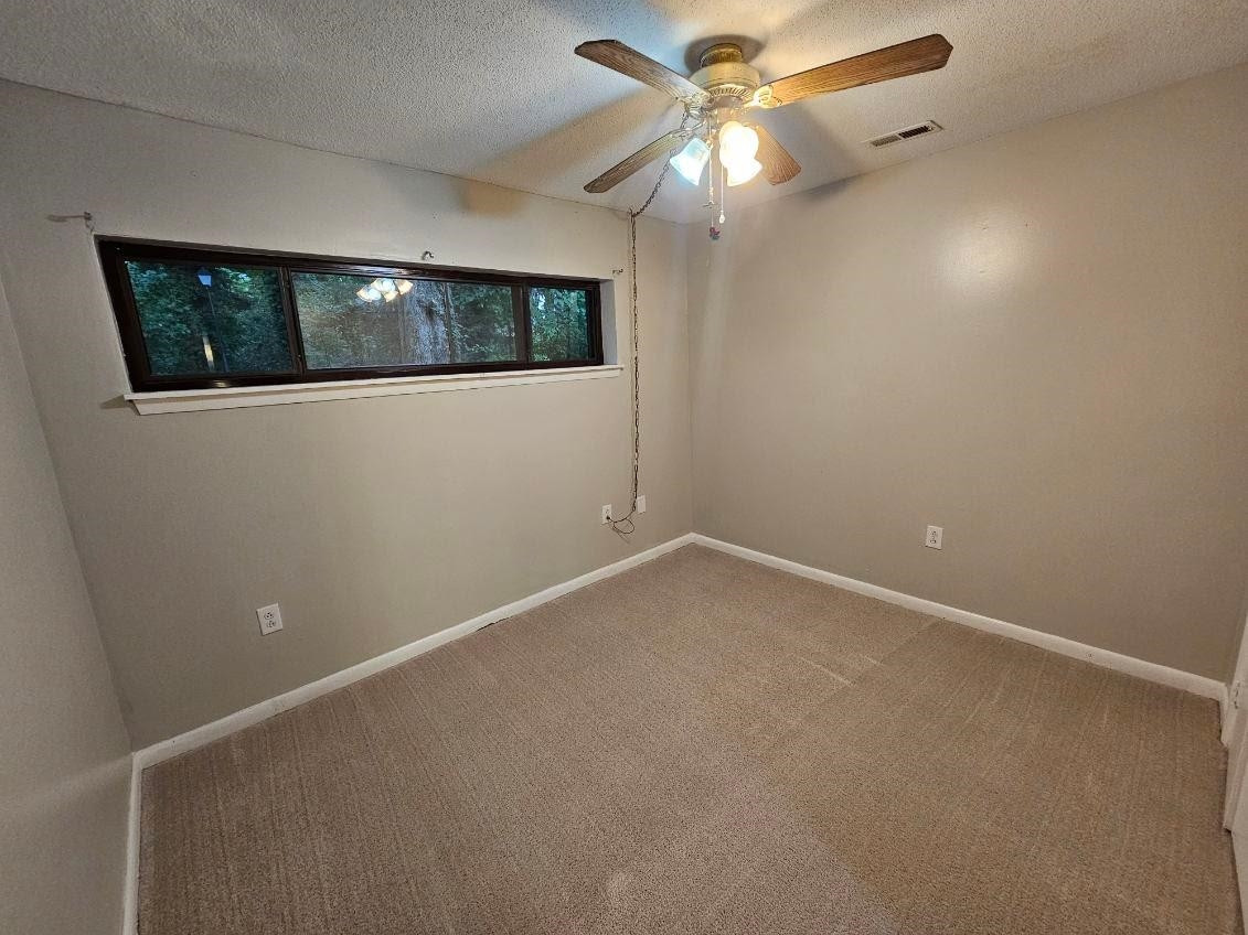 5052 Flint Ridge Place, Unit 5052 Raleigh, NC 27609 - Photo 33 of 67 an empty room with a window and a fan