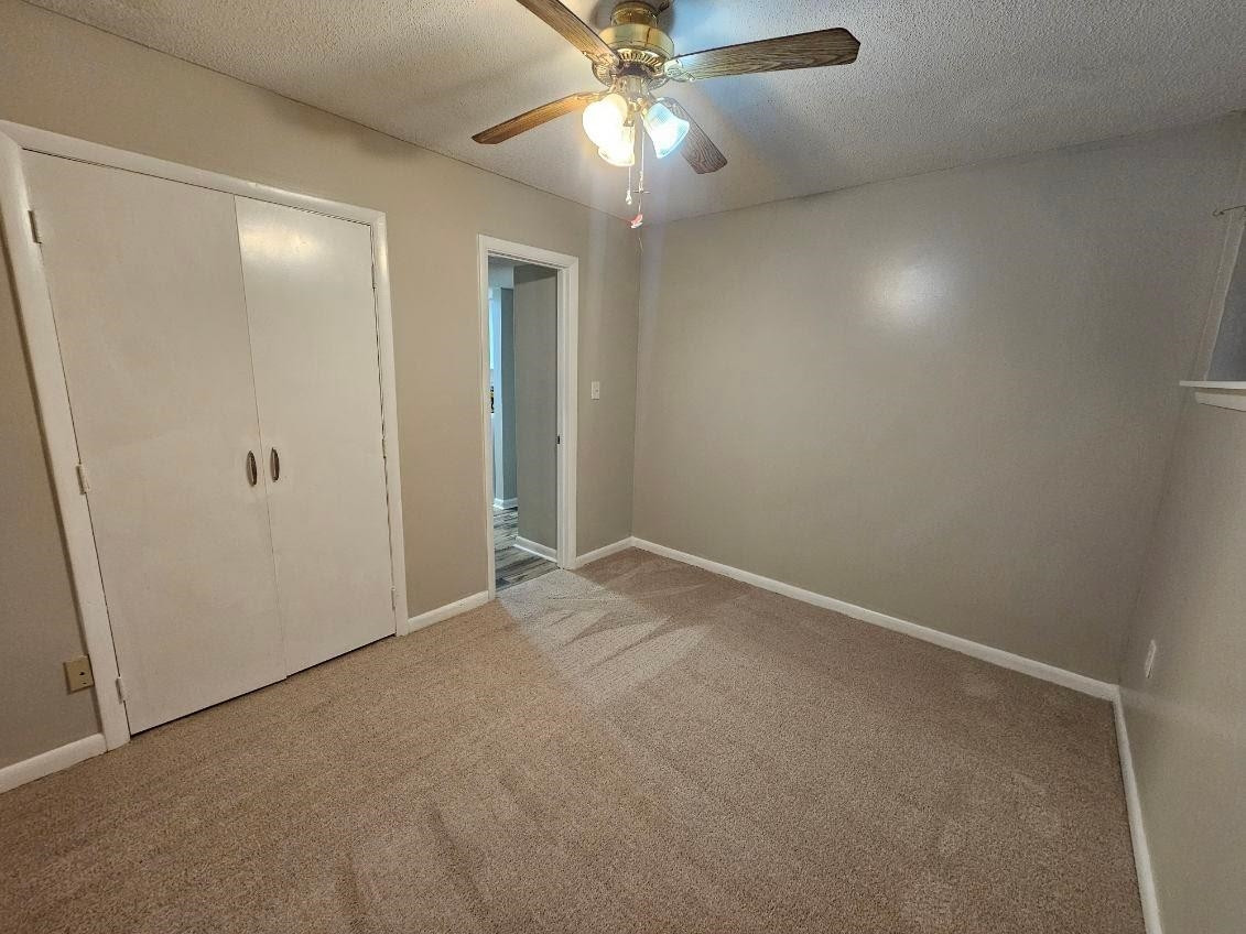 5052 Flint Ridge Place, Unit 5052 Raleigh, NC 27609 - Photo 34 of 67 an empty room with closet and a chandelier fan