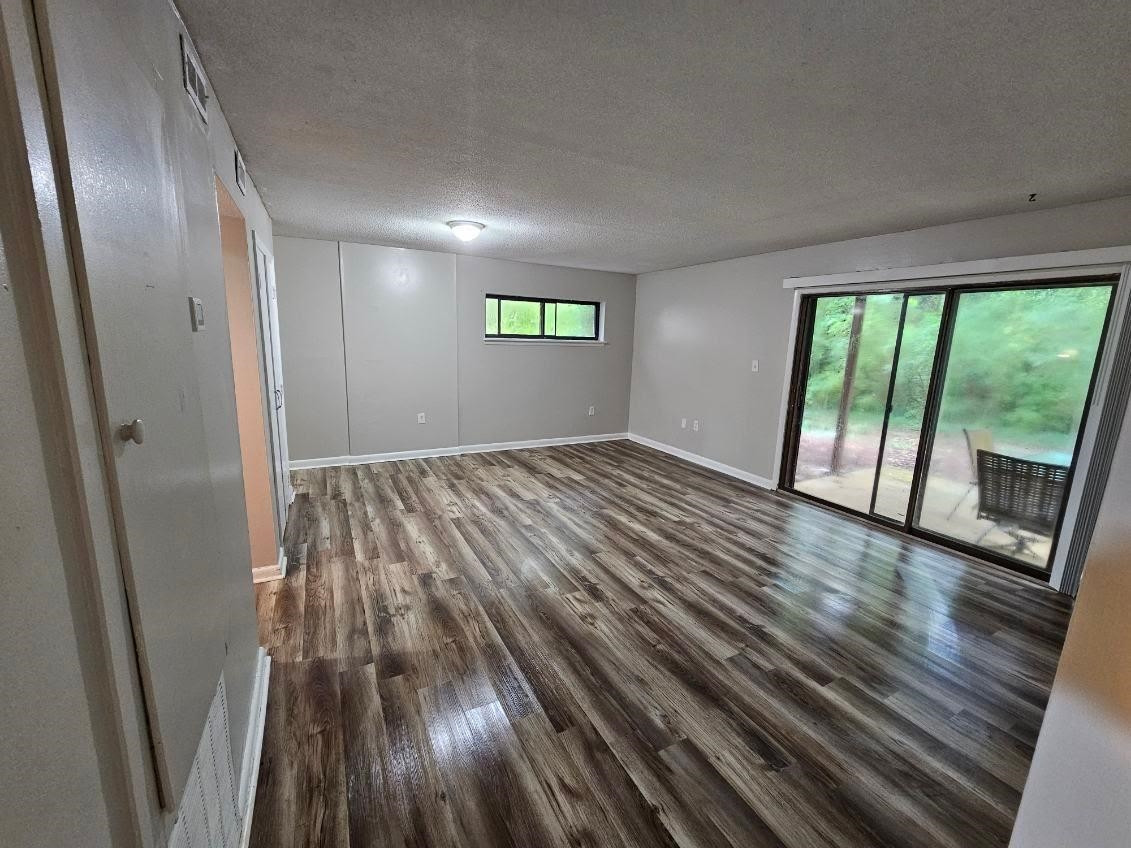 5052 Flint Ridge Place, Unit 5052 Raleigh, NC 27609 - Photo 37 of 67 an empty room with wooden floor and windows