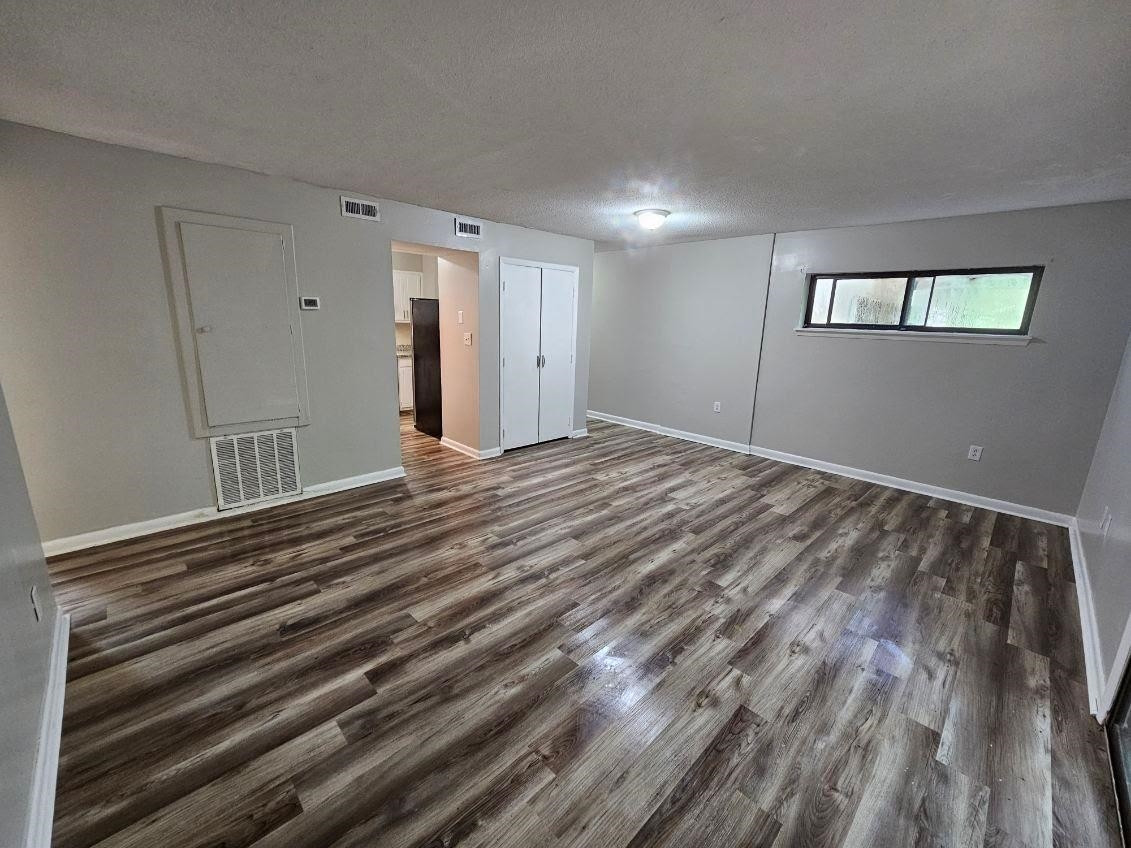 5052 Flint Ridge Place, Unit 5052 Raleigh, NC 27609 - Photo 40 of 67 a view of an empty room with wooden floor and a window