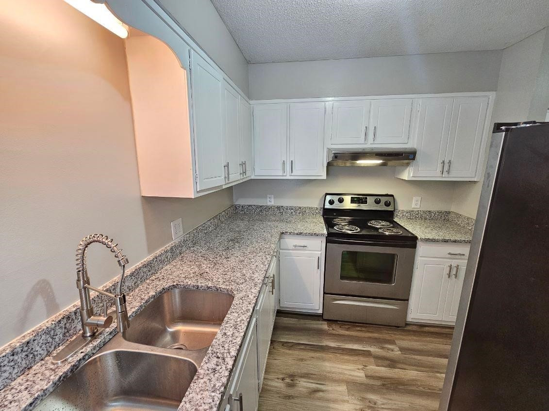 5052 Flint Ridge Place, Unit 5052 Raleigh, NC 27609 - Photo 4 of 67 a kitchen with granite countertop a sink and a stove top oven