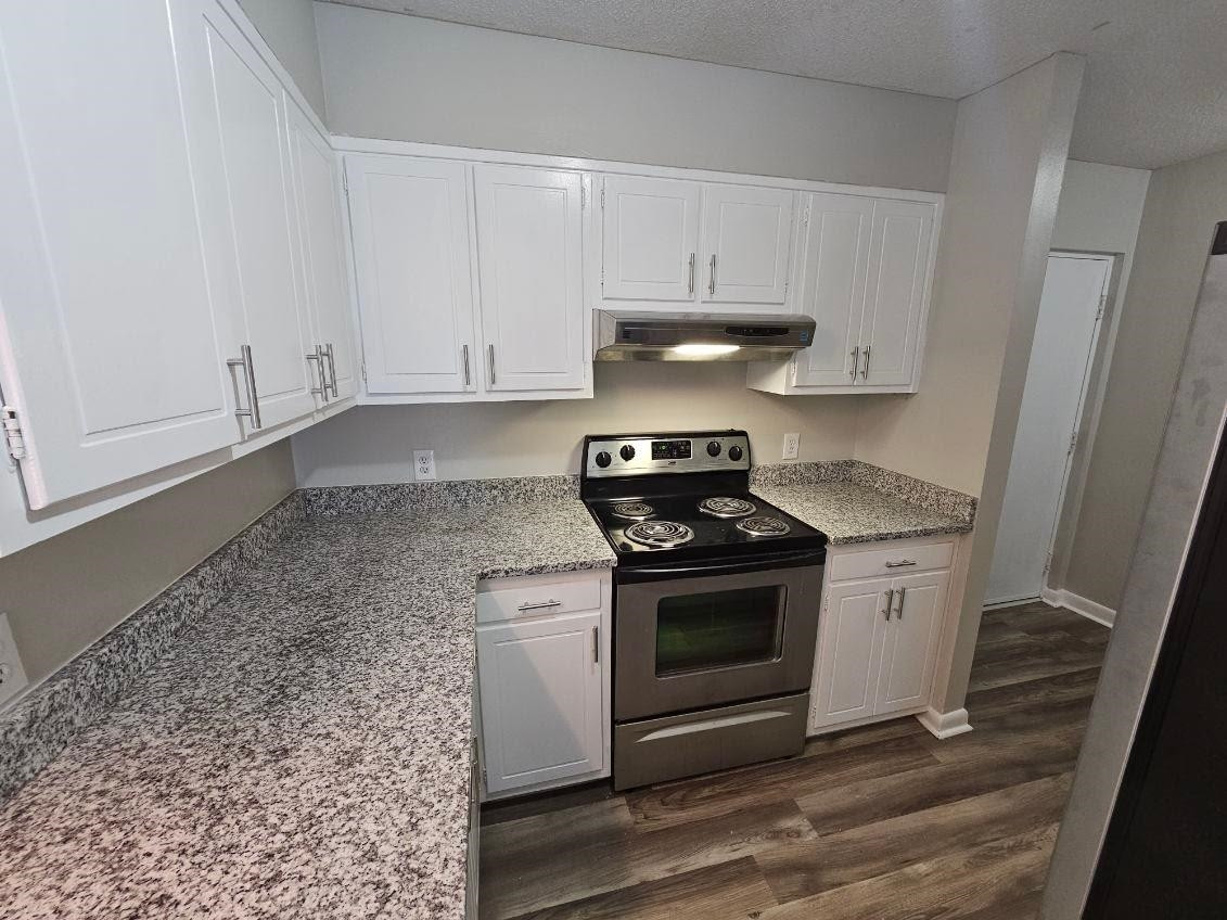 5052 Flint Ridge Place, Unit 5052 Raleigh, NC 27609 - Photo 6 of 67 a kitchen with stainless steel appliances granite countertop a stove a white and a white cabinets
