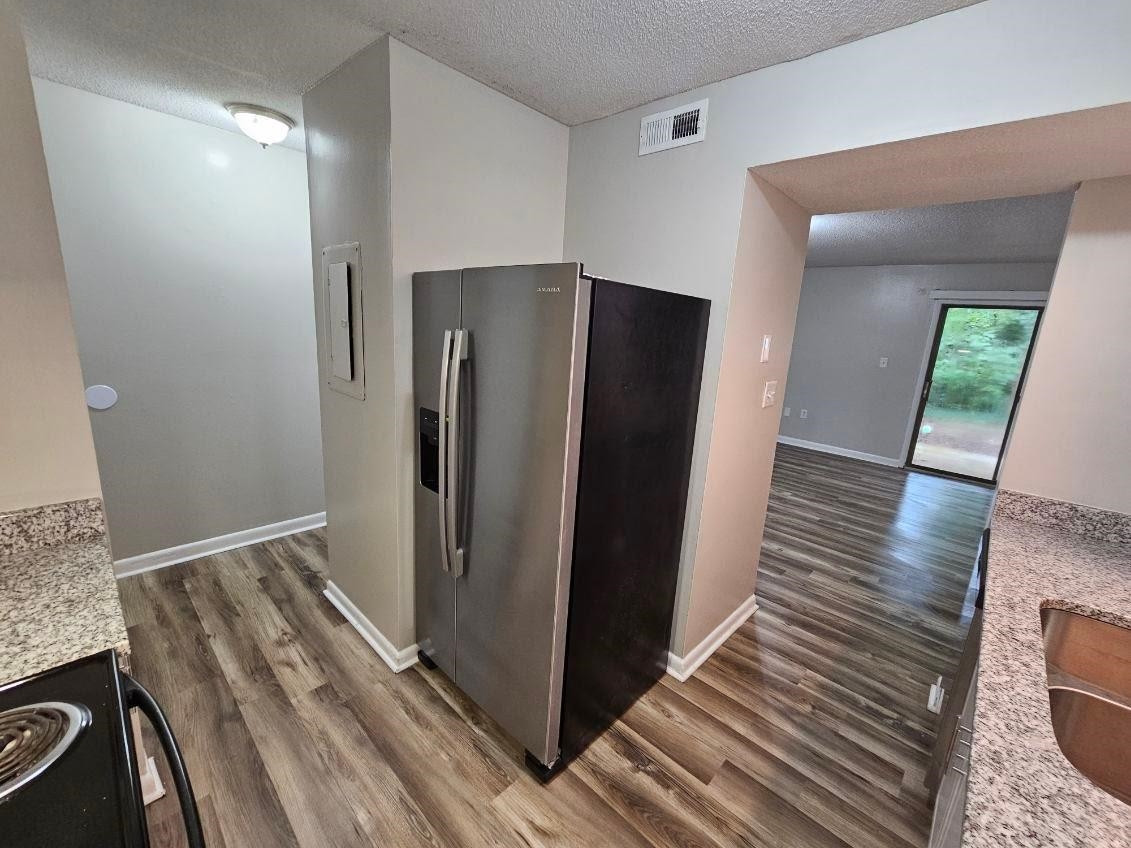 5052 Flint Ridge Place, Unit 5052 Raleigh, NC 27609 - Photo 10 of 67 a view of a refrigerator in kitchen and an empty room