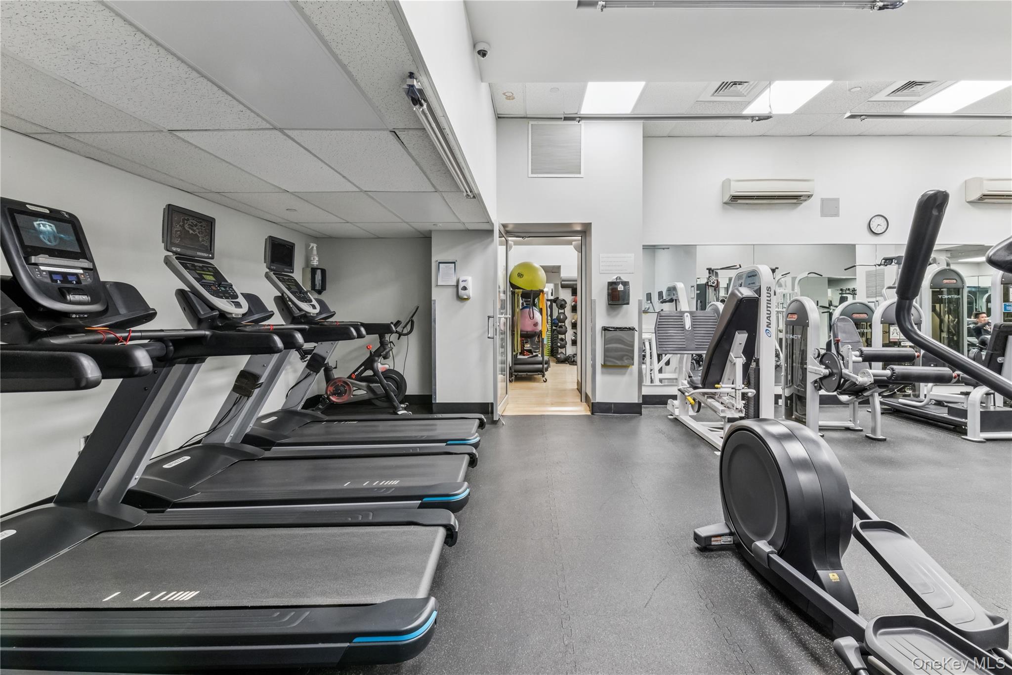 4-74 48th Avenue, Unit PH4D Queens, NY 11109 - Photo 15 of 28 a view of a room with gym equipment