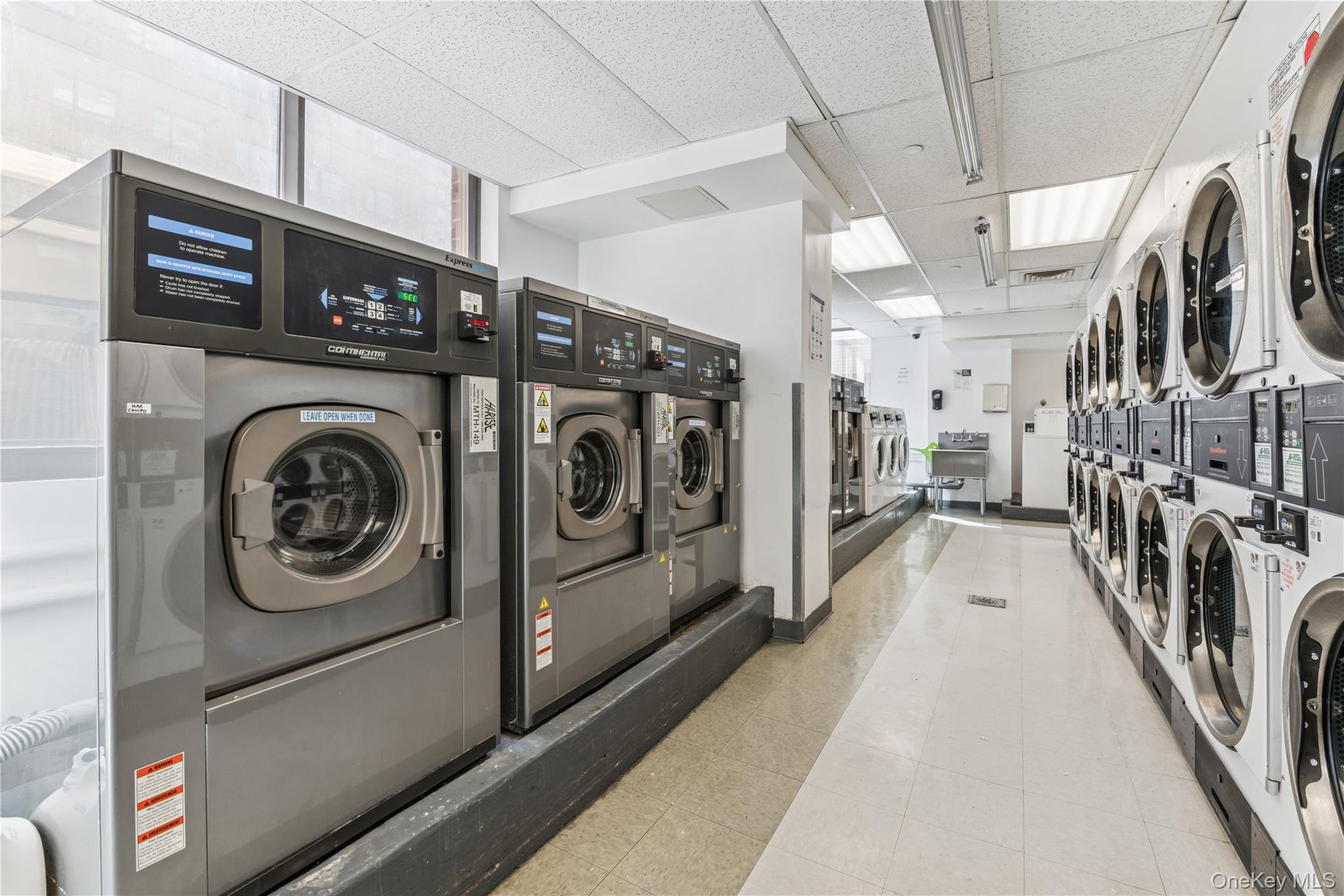 4-74 48th Avenue, Unit PH4D Queens, NY 11109 - Photo 20 of 28 a utility room with dryer and washer
