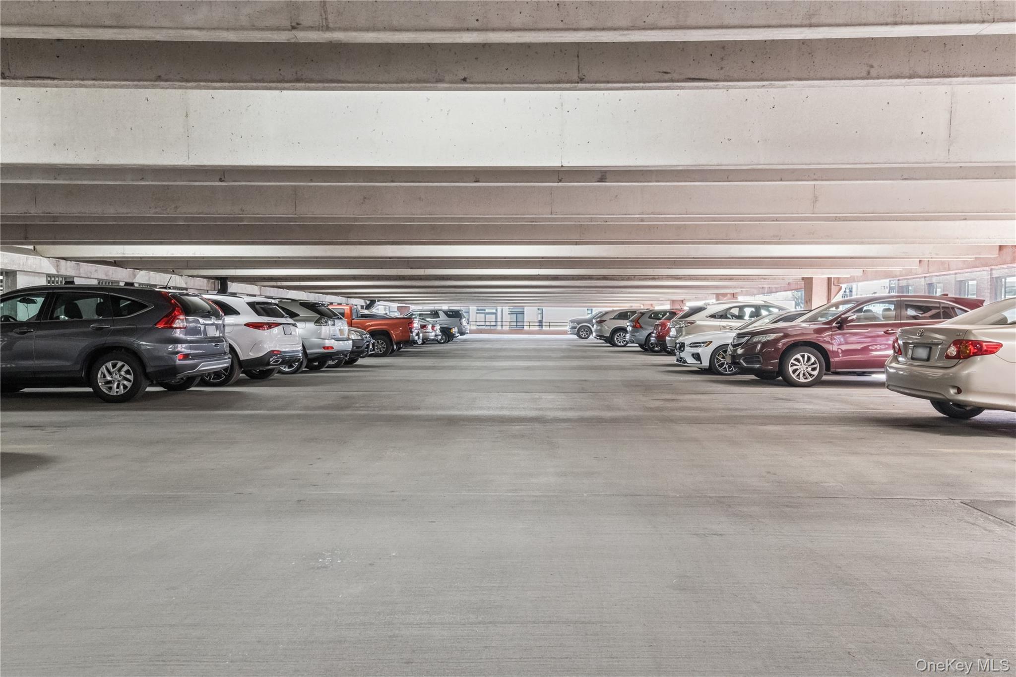4-74 48th Avenue, Unit PH4D Queens, NY 11109 - Photo 22 of 28 a view of car parked in garage
