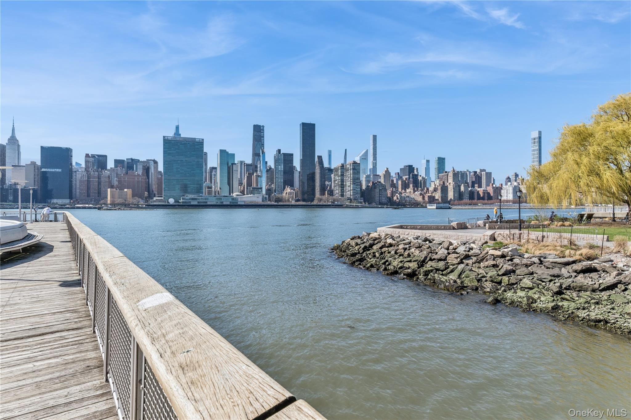 4-74 48th Avenue, Unit PH4D Queens, NY 11109 - Photo 28 of 28 a view of a lake with a large building