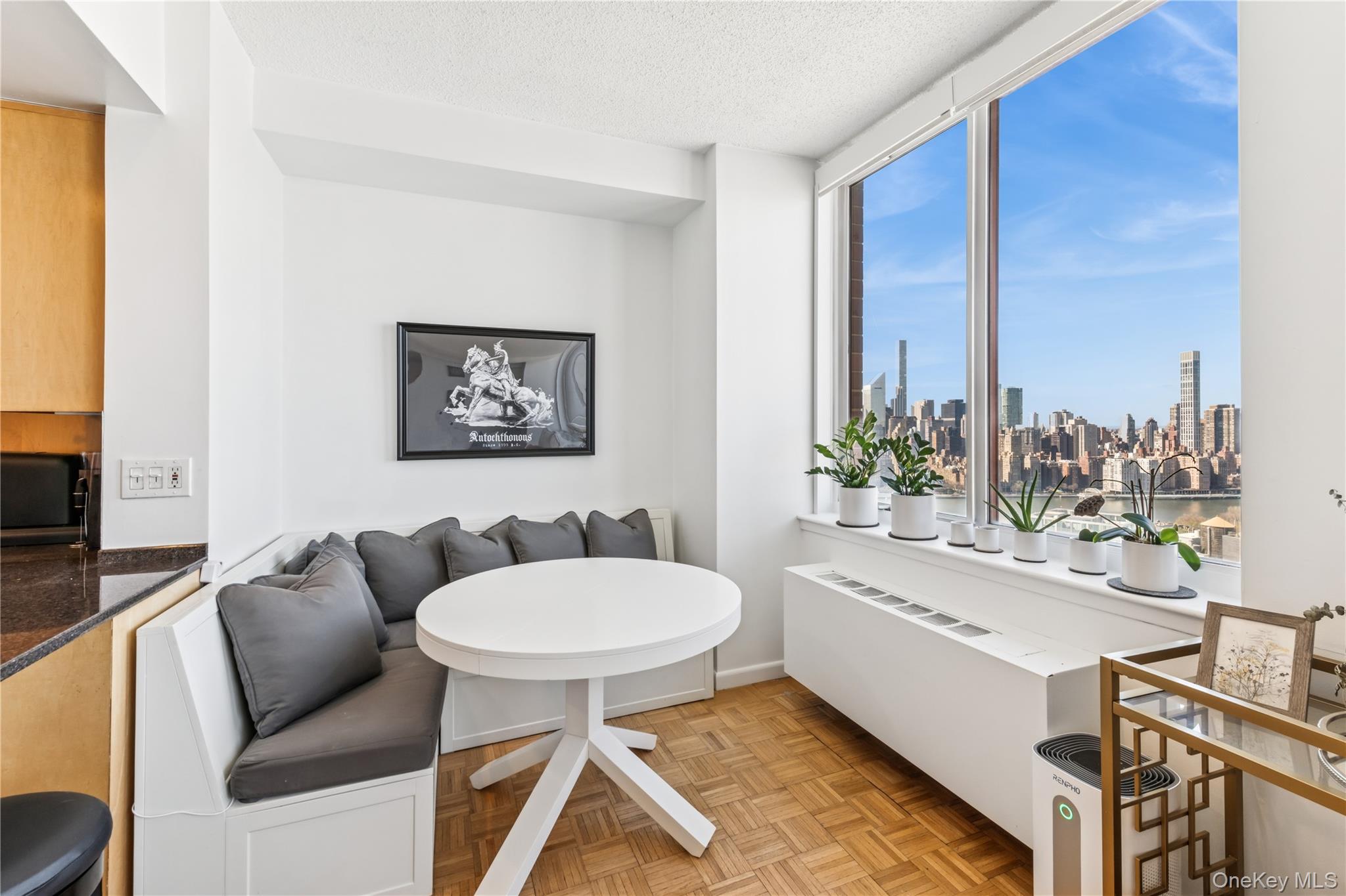 4-74 48th Avenue, Unit PH4D Queens, NY 11109 - Photo 4 of 28 a living room with furniture and a flat screen tv