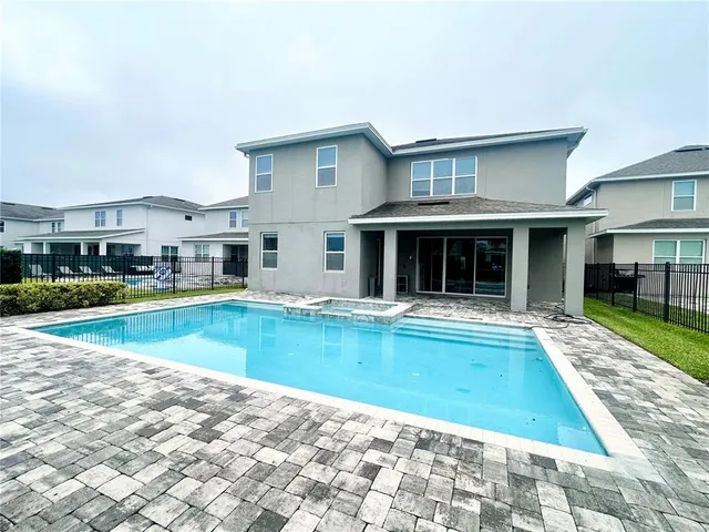 a view of a house with swimming pool and a yard